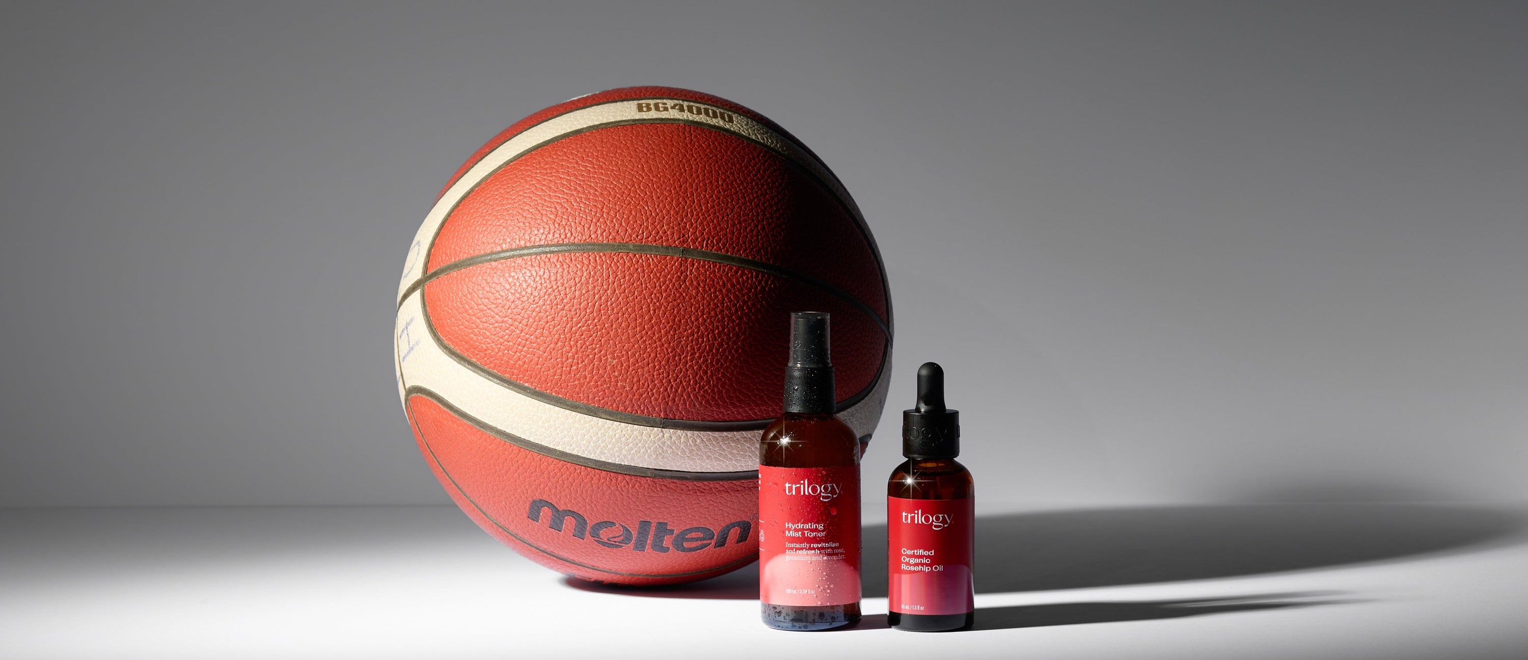Basketball and two bottles of Molteni on a gray background